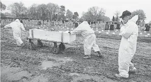  ?? CHRIS PEDOTA/ USA TODAY NETWORK ?? Rabbi Shmuel Plafker follows a casket to be buried at the Mount Richmond Cemetery on April 30, 2020, in Staten Island, N. Y. The Hebrew Free Burial Associatio­n provides for indigent members of the Jewish community. COVID- 19 deaths increased the need for burial space.