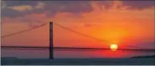  ?? ASSOCIATED PRESS ?? The sun sets over the Mackinac Bridge and the Mackinac Straits as seen from Lake Huron in 2002. The bridge is the dividing line between Lake Michigan to the west and Lake Huron to the east. Michigan’s attorney general, Republican Bill Schuette, called...