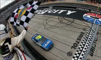  ?? SEAN GARDNER, GETTY IMAGES ?? Jimmie Johnson crosses the finish line to win the weather-delayed Food City 500 at Bristol Motor Speedway.