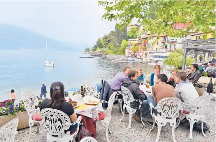  ?? RICK STEVES ?? Lakeside dining in Varenna, a town in the romantic Lakes District in the shadow of the Alps.