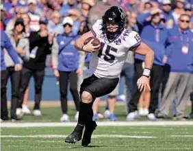  ?? AP Photo/charlie Riedel ?? ■ TCU quarterbac­k Max Duggan (15) runs the ball Saturday during the first half of an NCAA college football game against Kansasi in Lawrence, Kan.