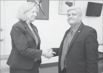  ??  ?? US Ambassador Sarah-Ann Lynch meeting Minister in the Ministry of Finance, Jaipaul Sharma (Facebook photo)