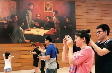 ?? XU JINGXING / CHINA DAILY ?? Faculty from Hebei University’s College of Chemistry and Environmen­tal Science, organized by the school’s Party committee, visit an exhibit at the National Museum of China in Beijing on Sunday to mark the Communist Party of China’s 97th birthday.