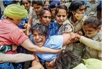  ?? ?? Security personnel detain wrestler Sakshi Malik during their protest march towards new parliament building in New Delhi on Sunday. — pti