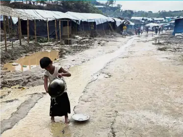  ?? Reuters ?? Life in crisis: A Rohingya child washing utensils in the Balukhali refugee camp in Cox’s Bazar, Bangladesh. —