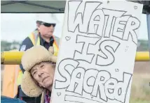  ?? ANDREW VAUGHN, CANADIAN PRESS ?? Annabelle Thiebaux protests at the entrance of a worksite near the Shubenacad­ie River in Fort Ellis, N.S.