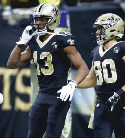  ?? GETTY IMAGES ?? Michael Thomas paid homage to a memorable play in Saints history by using a flip phone as a prop to celebrate his late 72-yard touchdown catch.