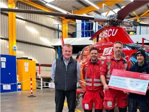  ?? ?? Thomas Mcpeake hands over a cheque to the NI Air Ambulance