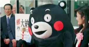  ?? — AP ?? Four-time Olympic wrestling champion Kaori Icho along with Kumamon, the mascot of Japan’s Kumamoto Prefecture, at a ceremony of the last trading day at the Tokyo Stock Exchange.