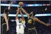  ?? JEFF CHIU — THE ASSOCIATED PRESS ?? Warriors forward Andrew Wiggins (22) blocks a shot by Utah Jazz forward Rudy Gay (8) during the second half in San Francisco on Sunday.