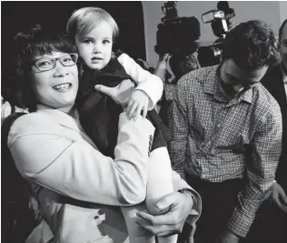  ?? NATHAN DENETTE/ THE CANADIAN PRESS ?? Toronto mayoral candidate Olivia Chow holds her granddaugh­ter Solace Campbell, 2, after announcing her candidacy on Thursday. She did not reveal her full platform to gathered supporters.