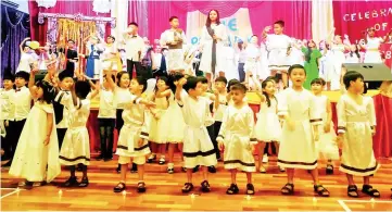  ??  ?? Primary students perform the ceremony’s grand finale song ‘Moana - How Far I’ll Go’.