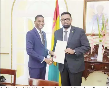  ?? ?? President Irfaan Ali (right) handing over the document of accession on December 6, 2022 to the Chair of the Ministeria­l Council of the RSS, Prime Minister of Grenada, Dickon Mitchell. (Office of the President photo)