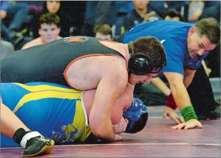  ?? DANA JENSEN/THE DAY ?? Montville’s Darrick Deveau puts a pinning combinatio­n on Gilbert’s Dylan Keith during their 285-pound semifinal match at the Class S state wrestling tournament on Saturday at Windham High School. Deveau pinned Keith in 4 minutes, 20 seconds, and he pinned all four of his opponents en route to winning the individual title. Visit www.theday.com to few a photo gallery.