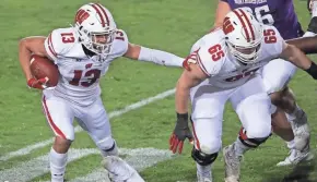  ?? MARK HOFFMAN / MILWAUKEE JOURNAL SENTINEL ?? Tyler Beach, right, is UW’s projected starter at left tackle, but has been sitting out with a left-leg injury.