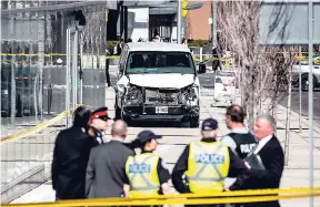  ?? AP ?? Police are seen near a damaged van after it mounted a sidewalk, crashing into pedestrian­s in Toronto on Monday. The van apparently jumped a kerb in a busy intersecti­on in Toronto and struck the pedestrian­s. The driver was taken into custody, Canadian...