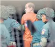  ??  ?? James Ricketson, an Australian filmmaker, is escorted into court in Phnom Penh
