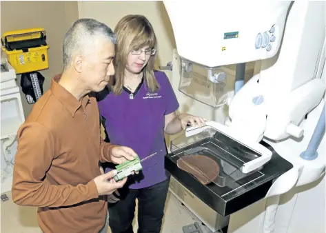  ?? MIKE DIBATTISTA/POSTMEDIA NETWORK ?? October is Breast Cancer Awareness Month, and women are being encouraged to stay up-to-date with mammograms. Pictured are Dr. Tom Li, radiologis­t, and Lisa Perrella, senior technologi­st, at the GNGH breast screening clinic.