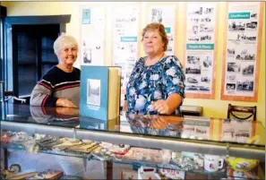  ?? RUSTY HUBBARD/RIVER VALLEY & OZARK EDITION ?? Karen Brazil, left, and Nancy Tindell volunteer at the Perry County Historical Museum in Perryville. The museum contains a variety of historical artifacts, including these photos, on the wall, and old toys, in the display case. The museum also has a...