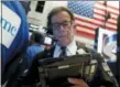  ?? RICHARD DREW — THE ASSOCIATED PRESS ?? Trader Sal Suarino works Tuesday on the floor of the New York Stock Exchange.