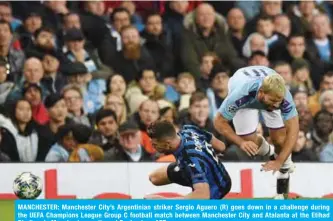  ??  ?? MANCHESTER: Manchester City’s Argentinia­n striker Sergio Aguero (R) goes down in a challenge during the UEFA Champions League Group C football match between Manchester City and Atalanta at the Etihad Stadium in Manchester, northwest England. — AFP