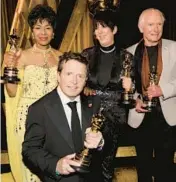  ?? KEVIN WINTER/GETTY ?? Euzhan Palcy, from left, Michael J. Fox, Diane Warren and Peter Weir hold their honorary Oscars on Saturday at the Governors Awards in Los Angeles.