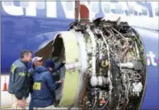  ?? NTSB VIA AP ?? National Transporta­tion Safety Board investigat­ors examine damage to the engine of the Southwest Airlines plane that made an emergency landing at Philadelph­ia Internatio­nal Airport in Philadelph­ia on Tuesday. The Southwest Airlines jet blew the engine...