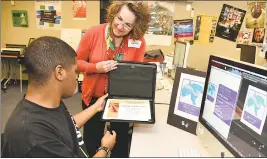  ?? SUBMITTED PHOTO ?? Bryce Demby, Interactiv­e Media Production student at Robert D. Stethem Educationa­l Center, receives a certificat­e of appreciati­on from Mediation Center Coordinato­r Julie Walton for his design of the center’s logo.