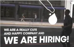  ??  ?? Photo shows a ‘hiring’ sign is posted on the window of a business in San Francisco. American workers saw the biggest bump in pay in nearly a decade last month amid a surprise latesummer hiring spree that offered no sign jobs markets could be cooling, the government reported. — AFP photo