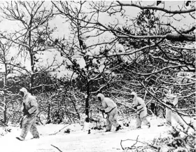  ??  ?? Above: Canadian troops patrol snowy forests in eastern Netherland­s, near the German border, during the winter of 1945.