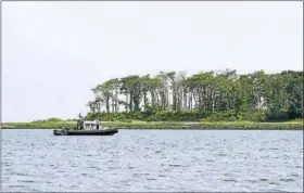  ?? ARNOLD GOLD / HEARST CONNECTICU­T MEDIA ?? A boat searches for a man swept off a sandbar in Long Island Sound off Milford on Friday.