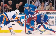  ?? AP ?? Islanders centre Anders Lee, left, scores against the Rangers.