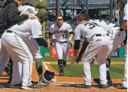  ?? Gene J. Puskar / Associated Press ?? Corey Dickerson prepares to be greeted by his teammates after hitting a game-winning homer.