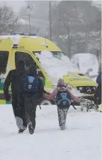  ??  ?? Members of the public return the favour, and head to help out an ambulance crew stranded in the snow in Dublin