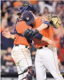  ?? ERIC CHRISTIAN SMITH/ASSOCIATED PRESS ?? Astros relief pitcher Ken Giles, right, hugs catcher Max Stassi after their win over Oakland last week.