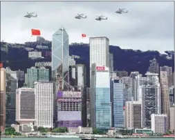  ?? ZHANG WEI / CHINA NEWS SERVICE ?? Helicopter­s fly over Golden Bauhinia Square in Hong Kong on July 1.