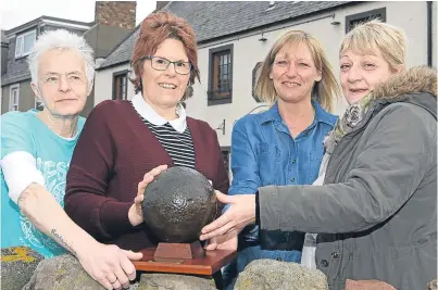  ??  ?? Cannonball­s from the attack are also at the Old Brewhouse pub and restaurant in Arbroath. From left: kitchen porter Margaret Tolmie, owner Paula Batard, Tracey Ross, front of house, and head chef Lorraine Pearson with one of the missiles.