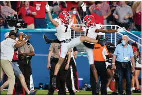  ?? LYNNE SLADKY — THE ASSOCIATED PRESS ?? Georgia wide receiver Jermaine Burton celebrates after scoring with wide receiver George Pickens against Michigan during the first half of the Orange Bowl College Football Playoff semifinal Dec. 31 in Miami Gardens, Fla.