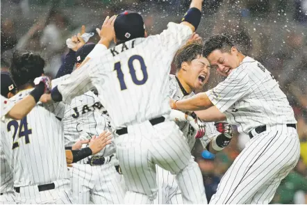  ?? PHOTOS BY WILFREDO LEE/THE ASSOCIATED PRESS ?? ABOVE: Japan players celebrate Monday after defeating Mexico 6-5 in a World Baseball Classic semifinal in Miami. Japan will face the United States in the final at 5 p.m. today in Miami. BELOW: Japan’s Shohei Ohtani celebrates after hitting a double during the ninth inning.