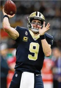  ?? SEAN GARDNER / GETTY IMAGES ?? Drew Brees warms up before going up against the Falcons on Thursday. Brees completed 76.9 percent of his passes with 25 touchdown passes going into the game.