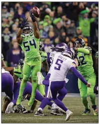  ?? AP/STEPHEN BRASHEAR ?? Linebacker Bobby Wagner (54) of the Seattle Seahawks leaps to block a field-goal attempt by Dan Bailey of Minnesota in the Seahawks’ 21-7 victory Monday night. The block became controvers­ial as to whether Wagner used his hands to gain leverage off a teammate to block the kick.