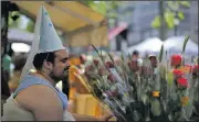  ?? AP/MANU FERNANDEZ ?? A man sells roses during the Sant Jordi festivity on Ramblas street in Barcelona, Spain, on Sunday. Sant Jordi’s Day, known as The Day of the Rose and the Book, is a Catalan celebratio­n where traditiona­lly men and women exchange books and roses.