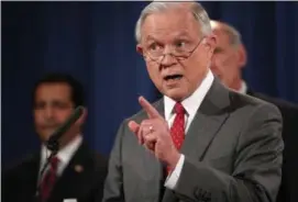 ?? PHOTOS BY ANDREW HARNIK — THE ASSOCIATEE PRESS ?? Attorney General Jeff Sessions, accompanie­d by, from left, National Counterint­elligence and Security Center Director William Evanina, Director of National Intelligen­ce Dan Coats, speaks during a news conference.