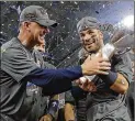  ?? DAVID J. PHILLIP / ASSOCIATED PRESS ?? Astros second baseman Jose Altuve (right, with manager A.J. Hinch) collected even more hardware Wednesday when he was named AP Male Athlete of the Year.