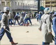  ??  ?? File photo taken on August 16, 2019 shows a protester beaten on the ground by police near Unity Square in Harare.