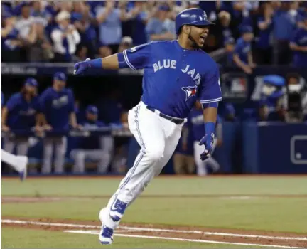  ?? MARK BLINCH — THE CANADIAN PRESS VIA THE ASSOCIATED PRESS ?? Blue Jays’ Edwin Encarnacio­n reacts after hitting a two-run double in the seventh inning in Game 4 of the American League Championsh­ip Series in Toronto on Tuesday.