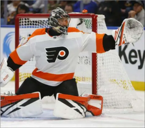  ?? JEFFREY T. BARNES — THE ASSOCIATED PRESS ?? Flyers goalie Anthony Stolarz reaches for the puck during the first period in Buffalo Saturday. Stolarz allowed a pair of early goals, but the Flyers responded to skate by the Sabres, 6-2.