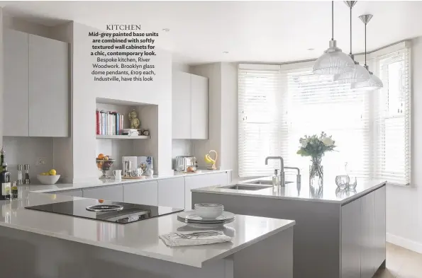  ??  ?? KITCHEN Mid-grey painted base units are combined with softly textured wall cabinets for a chic, contempora­ry look. Bespoke kitchen, River Woodwork. Brooklyn glass dome pendants, £109 each, Industvill­e, have this look