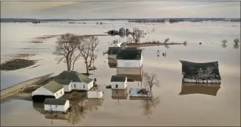  ??  ?? Floodwater surrounds a farm, near Craig, Missouri. Midwest states are battling some of the worst floodings they have experience­d in decades as rain and snowmelt from the recent ‘bomb cyclone’ has inundated rivers and streams. — AFP photo