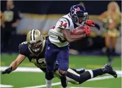  ?? Associated Press ?? n Houston Texans running back Tyler Ervin (34) rushes past New Orleans Saints linebacker Bryan Braman (42) in the first half of a preseason NFL football game Saturday in New Orleans.